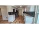 Modern kitchen with stainless steel appliances, stylish white cabinets, and a tiled backsplash at 1027 Fountainhead Dr, Largo, FL 33770