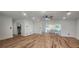 A spacious open-plan living area has wood floors, recessed lighting and a modern ceiling fan at 1027 Fountainhead Dr, Largo, FL 33770