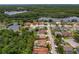 A bird's-eye view shows the home and its surrounding natural beauty, with a nearby lake enhancing its appeal at 1046 Middlesex Dr, New Port Richey, FL 34655
