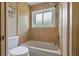This is a full bathroom with a tub and shower and large window at 1046 Middlesex Dr, New Port Richey, FL 34655