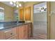 This bathroom features a wood cabinet and a view to the bedroom at 1046 Middlesex Dr, New Port Richey, FL 34655