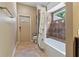 Well-lit bathroom with a shower-tub combination, updated tile and tile flooring at 1046 Middlesex Dr, New Port Richey, FL 34655