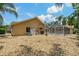 An outdoor view of the home's exterior and the screened pool area, highlighting the backyard's landscape at 1046 Middlesex Dr, New Port Richey, FL 34655