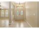 Inviting front entrance with tile flooring and decorative glass double doors and archway at 1046 Middlesex Dr, New Port Richey, FL 34655