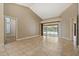 Spacious living area with tile flooring offers seamless access to the lanai and pool area at 1046 Middlesex Dr, New Port Richey, FL 34655