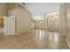 Open floor plan with tile floors, chandeliers, and view of the front door at 1046 Middlesex Dr, New Port Richey, FL 34655