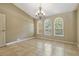 Bright living room featuring a chandelier and large windows offering plenty of natural light at 1046 Middlesex Dr, New Port Richey, FL 34655