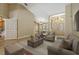 Spacious living room with a high ceiling, chandeliers and a welcoming double-door entryway at 1046 Middlesex Dr, New Port Richey, FL 34655