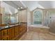 Luxurious main bathroom featuring dual sinks, a soaking tub, and a separate glass enclosed shower at 1046 Middlesex Dr, New Port Richey, FL 34655