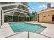 A covered swimming pool with an adjacent patio area, perfect for enjoying the outdoors at 1046 Middlesex Dr, New Port Richey, FL 34655