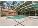 A screened-in pool with a large deck for entertaining at 1046 Middlesex Dr, New Port Richey, FL 34655