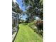 Expansive backyard with beautiful landscaping and a screened-in patio at 11501 Norval Pl, Temple Terrace, FL 33617