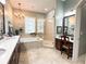 Bright bathroom with dual vanity, large window, and luxurious soaking tub at 11501 Norval Pl, Temple Terrace, FL 33617