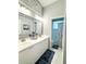 Bathroom featuring double sinks, white cabinets, and a shower/tub combo with blue accents at 11501 Norval Pl, Temple Terrace, FL 33617