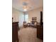 Bright bedroom featuring neutral carpet, ceiling fan, and a cozy seating area by the window at 11501 Norval Pl, Temple Terrace, FL 33617