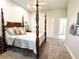 Bedroom showcasing a four-poster bed, neutral carpet, and bright, airy atmosphere at 11501 Norval Pl, Temple Terrace, FL 33617