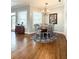 Charming dining area with natural light, hardwood floors, and a round table at 11501 Norval Pl, Temple Terrace, FL 33617
