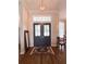 Elegant entryway with double doors, transom window, chandelier, and hardwood floors at 11501 Norval Pl, Temple Terrace, FL 33617