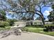 Well-maintained single-story home with a three-car garage and a large, shaded front yard at 11501 Norval Pl, Temple Terrace, FL 33617