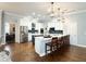 Modern kitchen featuring white cabinets, stainless steel appliances, and a large island with seating at 11501 Norval Pl, Temple Terrace, FL 33617