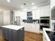 The kitchen boasts modern appliances, white cabinets, gold hardware and a beautiful tile backsplash at 11501 Norval Pl, Temple Terrace, FL 33617