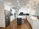 Bright kitchen features stainless steel appliances, an island, a stylish backsplash and ample counter space at 11501 Norval Pl, Temple Terrace, FL 33617