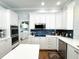 This spacious kitchen features a hood range, white cabinets and an adjacent laundry room at 11501 Norval Pl, Temple Terrace, FL 33617
