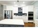 A bright kitchen features white cabinets, an island with a white counter top and stainless steel appliances at 11501 Norval Pl, Temple Terrace, FL 33617