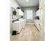 The laundry room boasts ample cabinet space, a sink, a window, and washer and dryer at 11501 Norval Pl, Temple Terrace, FL 33617
