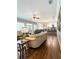 Open-concept living room connected to kitchen, featuring hardwood floors and ample seating at 11501 Norval Pl, Temple Terrace, FL 33617