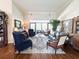 Spacious living room with high ceilings, hardwood floors, and comfortable seating arrangement at 11501 Norval Pl, Temple Terrace, FL 33617