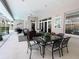 Relaxing outdoor patio with ceiling fans and elegant wrought iron dining set at 11501 Norval Pl, Temple Terrace, FL 33617
