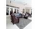 Inviting covered patio with comfortable wicker furniture and a stylish gray rug at 11501 Norval Pl, Temple Terrace, FL 33617