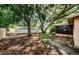 Spacious backyard featuring mature trees and a screened-in porch, offering privacy and shade at 11783 102Nd Ave, Largo, FL 33778