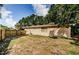 Large backyard with a well-kept lawn and a classic door, perfect for Gathering gatherings and pets at 11783 102Nd Ave, Largo, FL 33778