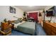 View of a bedroom with blue carpeting and dark wood furniture at 11783 102Nd Ave, Largo, FL 33778