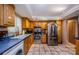 Bright kitchen features wooden cabinets, stainless steel appliances, and tiled floors at 11783 102Nd Ave, Largo, FL 33778