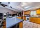 Spacious kitchen with an island, wooden cabinets, and stainless steel appliances at 11783 102Nd Ave, Largo, FL 33778