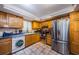 Bright kitchen features wooden cabinets, stainless steel appliances, and tiled floors at 11783 102Nd Ave, Largo, FL 33778