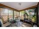 Enclosed patio featuring a glass table and grill for outdoor cooking at 11783 102Nd Ave, Largo, FL 33778