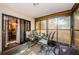 Enclosed patio featuring a glass table and grill for outdoor cooking at 11783 102Nd Ave, Largo, FL 33778