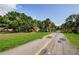Nice street view with plenty of trees, grass, and palm trees on either side of the street at 11783 102Nd Ave, Largo, FL 33778