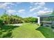 A spacious backyard with a lush lawn and mature trees and landscaping provides privacy at 13116 Marathon Blvd, Port Charlotte, FL 33981