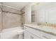 Bathroom featuring tile flooring, a tub and shower combination with decorative tiled backsplash, and vanity at 13116 Marathon Blvd, Port Charlotte, FL 33981