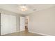 Comfortable bedroom features tile floors, a ceiling fan, and closet for ample storage space at 13116 Marathon Blvd, Port Charlotte, FL 33981