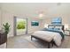 Stylishly furnished bedroom with large window, neutral decor, and a comfortable upholstered bench at 13116 Marathon Blvd, Port Charlotte, FL 33981