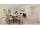 Dining area featuring a glass-topped table, seating for six, and sliding door access to the lanai at 13116 Marathon Blvd, Port Charlotte, FL 33981