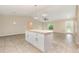 Open concept kitchen island featuring granite countertops, storage, and views into the living area at 13116 Marathon Blvd, Port Charlotte, FL 33981