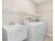 Well-equipped laundry room with utility sink and included washer and dryer for added convenience at 13116 Marathon Blvd, Port Charlotte, FL 33981