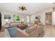 Bright living room featuring vaulted ceilings, tile flooring, and comfortable neutral furnishings at 13116 Marathon Blvd, Port Charlotte, FL 33981